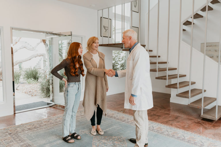 Physician welcoming a client and family member at Oro House in Malibu