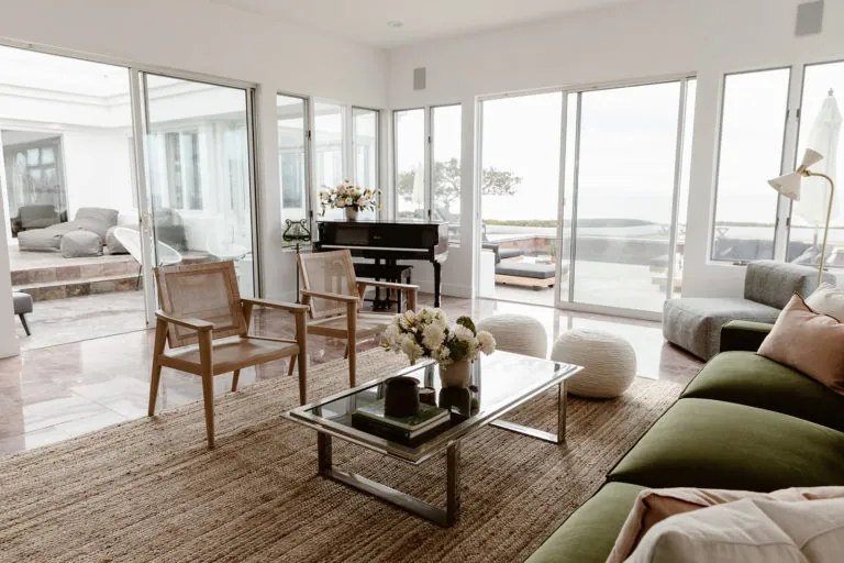 Living room with a grand piano at Oro House's luxury rehab in Malibu